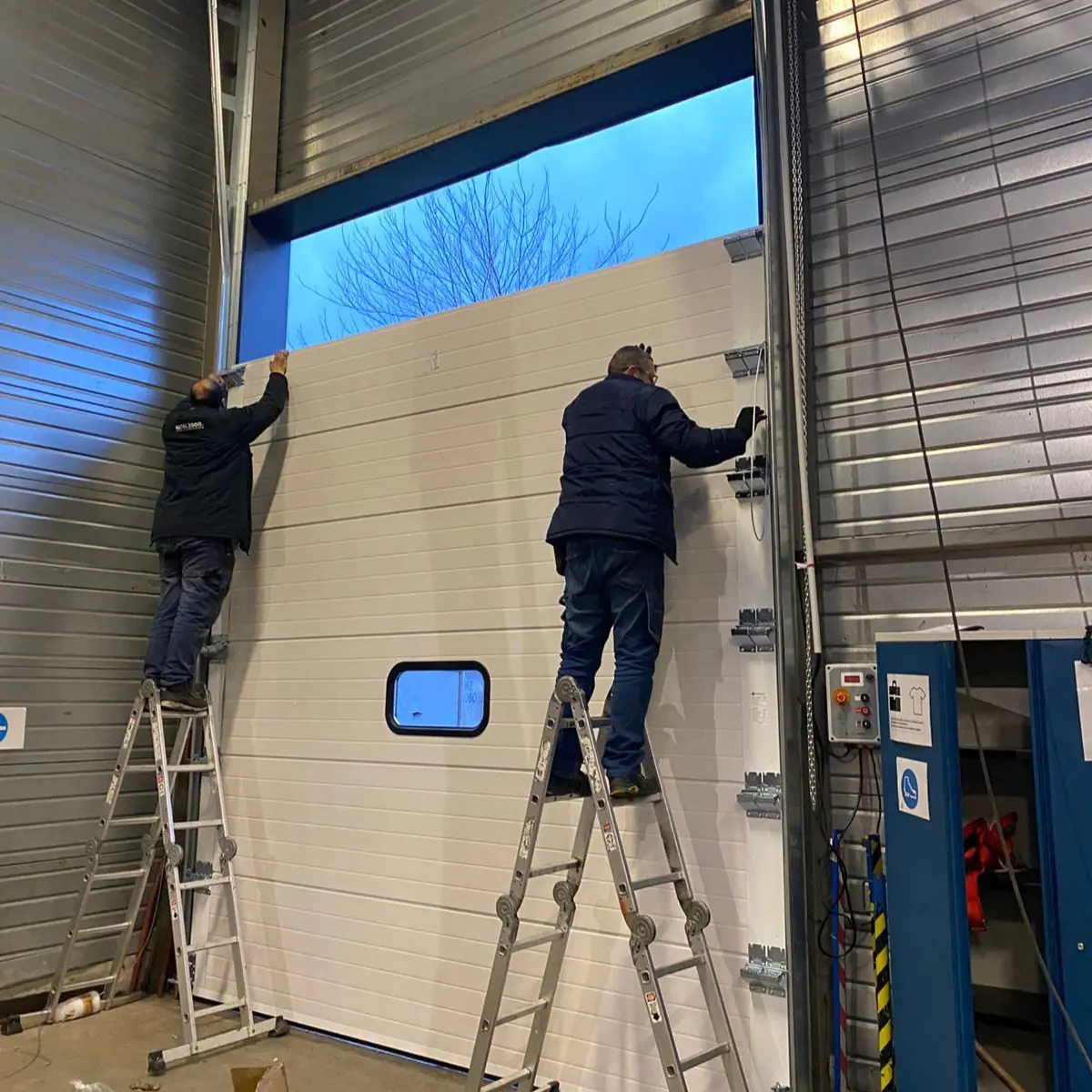 Changement panneaux porte sectionnelle industrielle Saint Omer