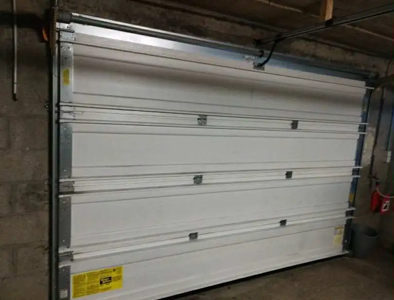 Réparation porte de garage sectionnelle Freneuse (78840)