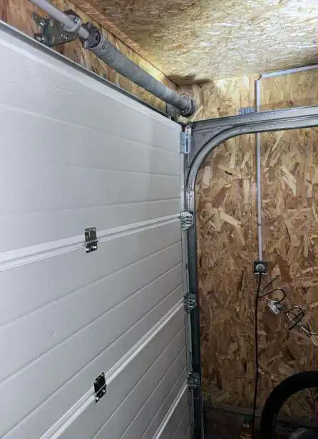 réparation de porte de garage sectionnelle à Nozay