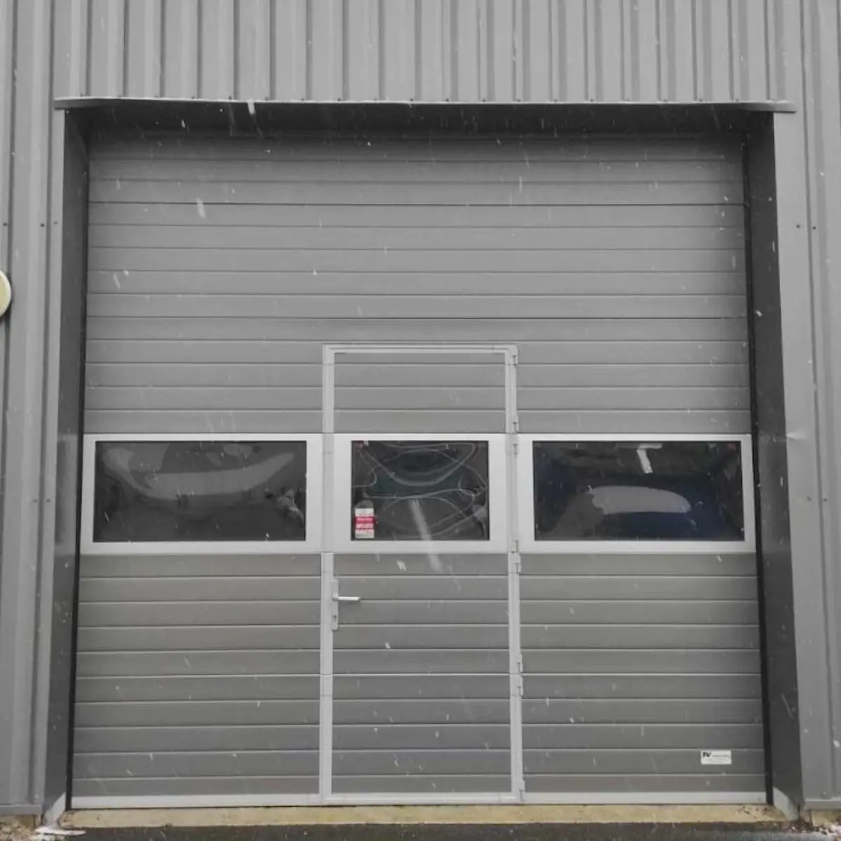 Réparation porte sectionnelle industrielle Auménancourt
