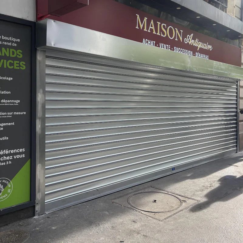 Création et installation d'un rideau métallique motorisé pour la boutique de Maison Antiquaire à Paris 15e