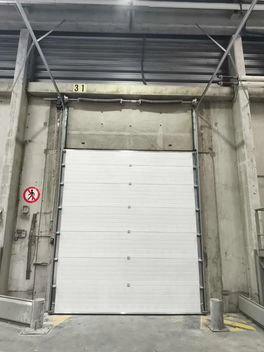 Réparation porte sectionnelle industrielle Omey
